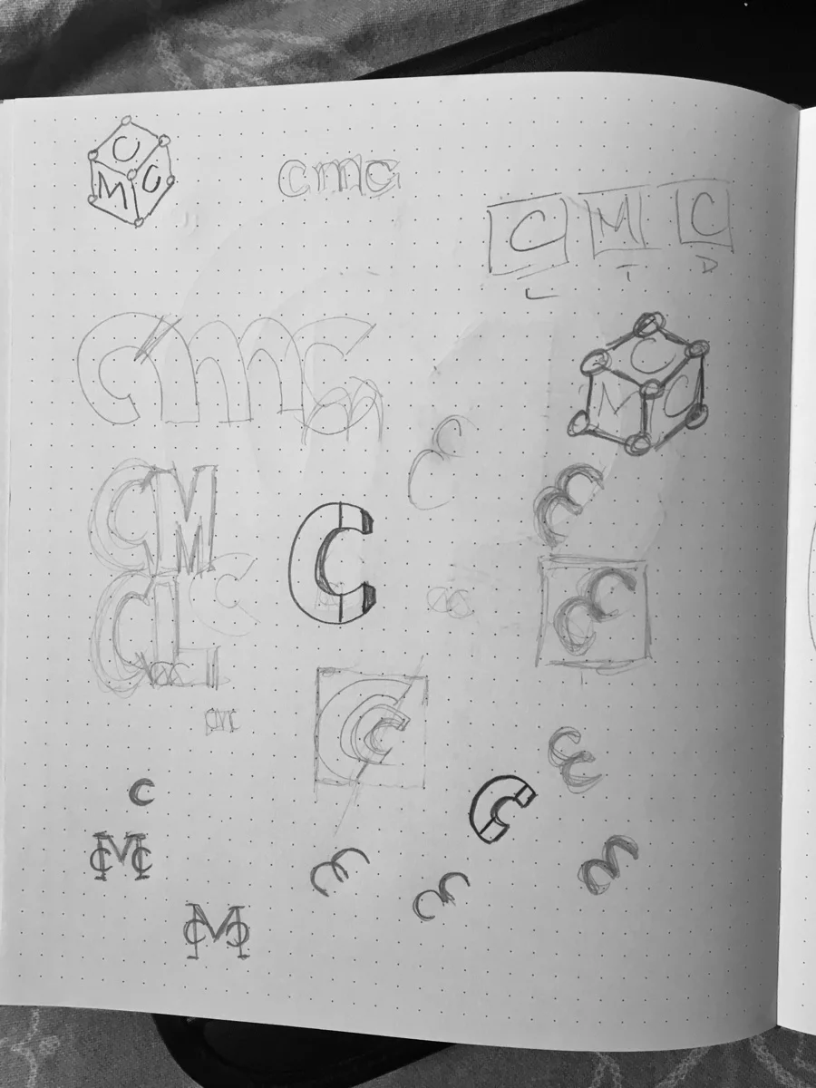 A page of dense pencil exploration: variations of a CMC monogram, dimensional cube constructions, an M nested inside opposing C-shapes, and a row of small abstract C-shapes being torn apart and rebuilt