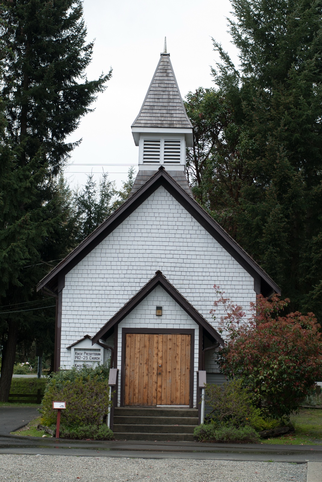 The white Knox Presbyterian Church with its distinctive steeple, the visual anchor of the Parksville Museum logo